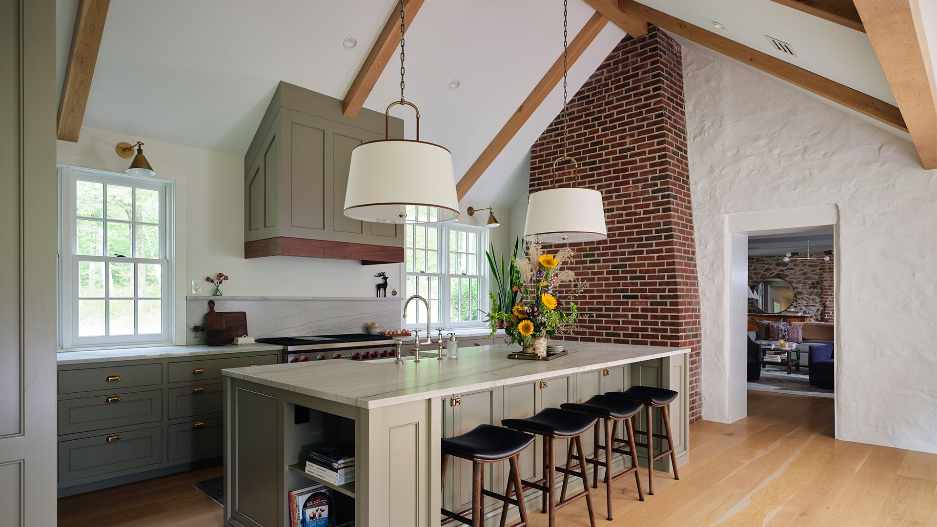 Elegant kitchen living room with brick and custom millwork